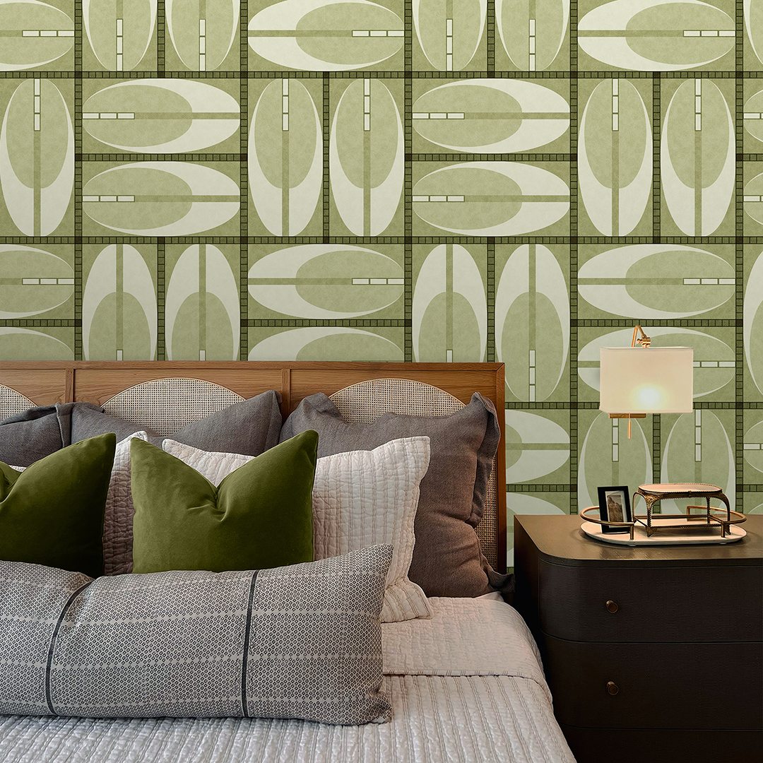 The artwork features a repeating geometric pattern of symmetrical shapes resembling elongated, curved diamonds or petals in various shades of blue and green. Each shape is split vertically with one half filled with a light blue and the other half filled with green or darker blue. The background is a light, almost pastel blue, which provides a soft yet vibrant backdrop. One of the blue shapes near the upper left contains a white starburst element, adding a focal point of brightness to the composition. The overall design conveys a modern, mid-century aesthetic with clean lines and harmonious color contrasts.